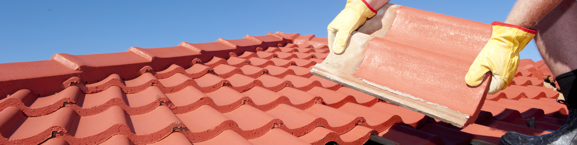 Man placing tile roof